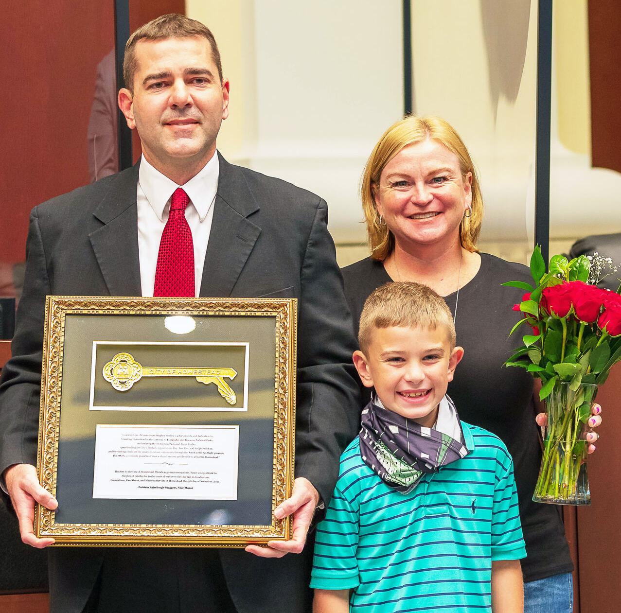Outgoing Councilman Stephen Shelley, joined by his family, displays his Key to the City awarded in recognition of his 12 years of service.